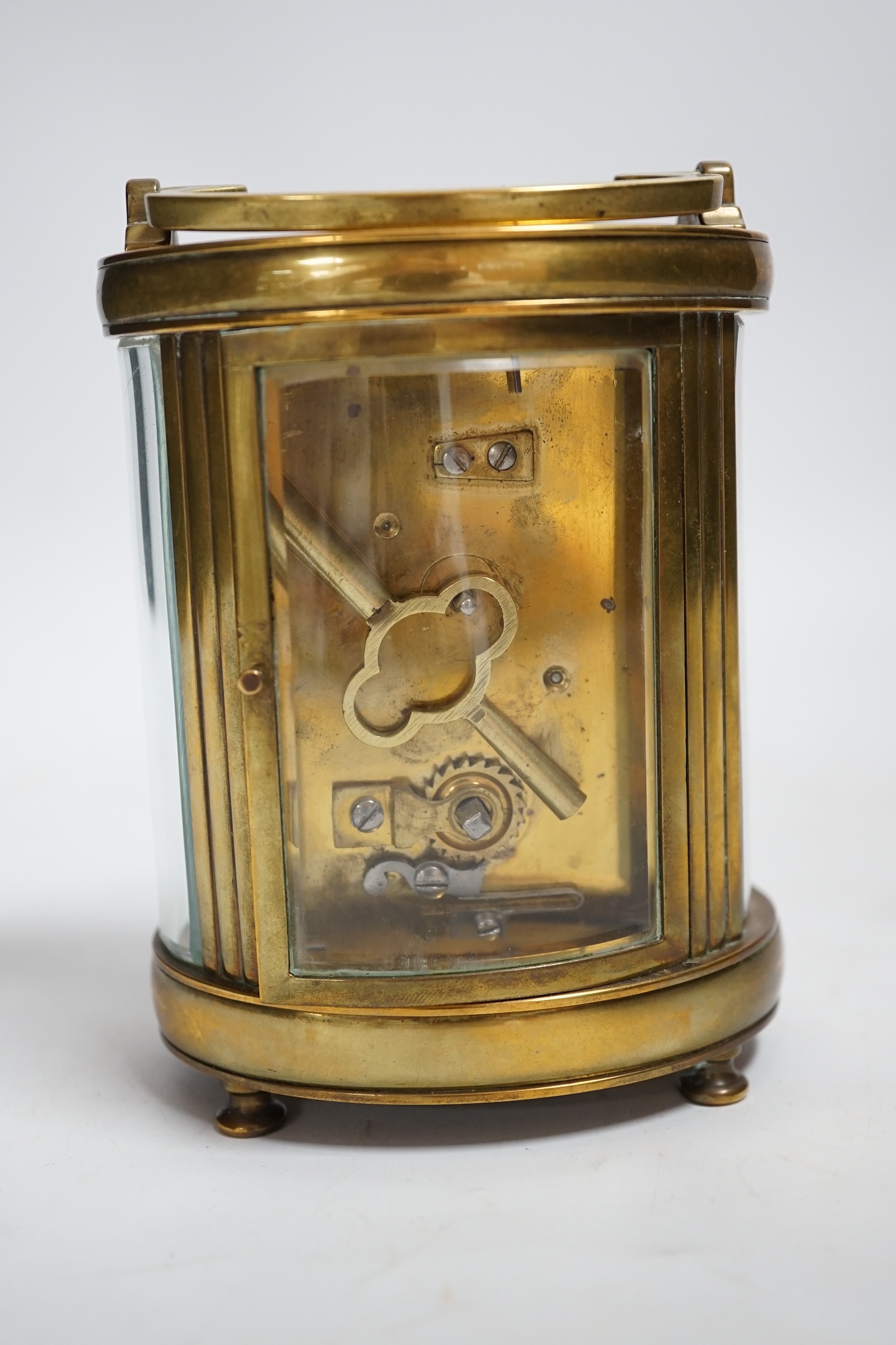 A brass oval cased carriage timepiece, stamped ‘Made in France’, 12cm
